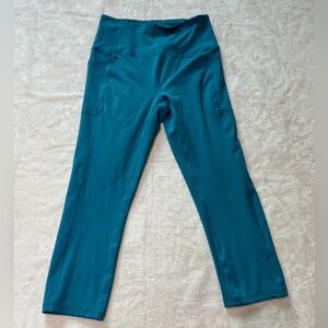 RBX Size Medium Blue Yoga Pants with Side Pockets. Polyester and spandex.